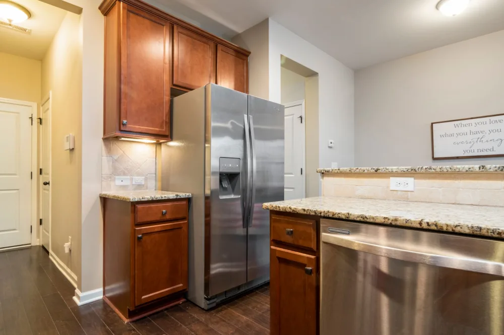 Elegant kitchen interior featuring stainless steel appliances and wooden cabinets.