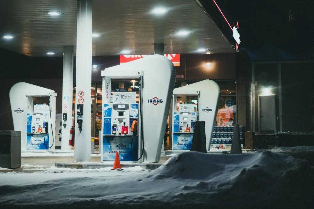 A well-lit gas station surrounded by snow during a winter night in St. John's, NL, Canada.