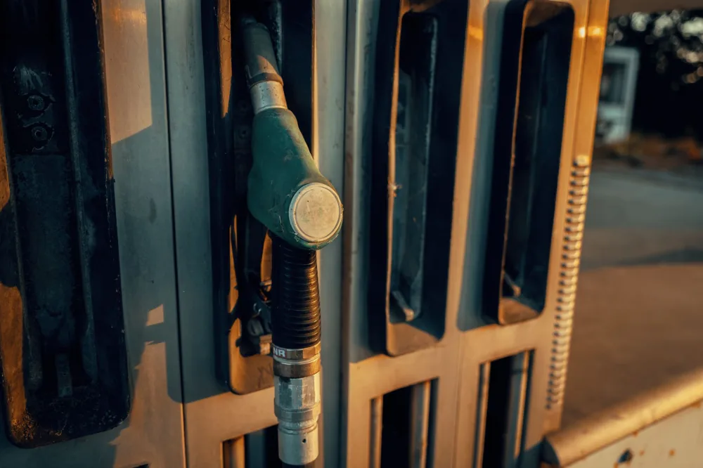 A detailed view of a gas pump nozzle during sunset in Österreich, highlighting industrial design.