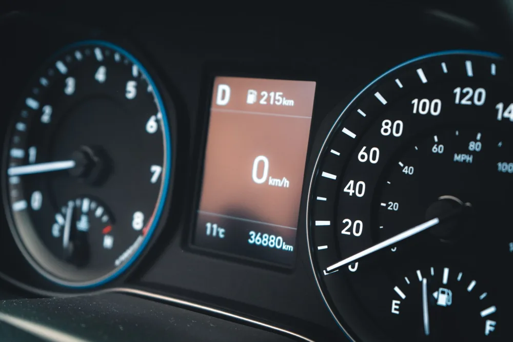 Detailed view of a car dashboard featuring speedometer and digital display showing 0 km/h.