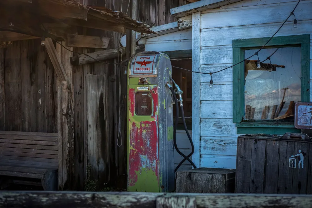 Old gas pump and weathered wooden building create a nostalgic scene.